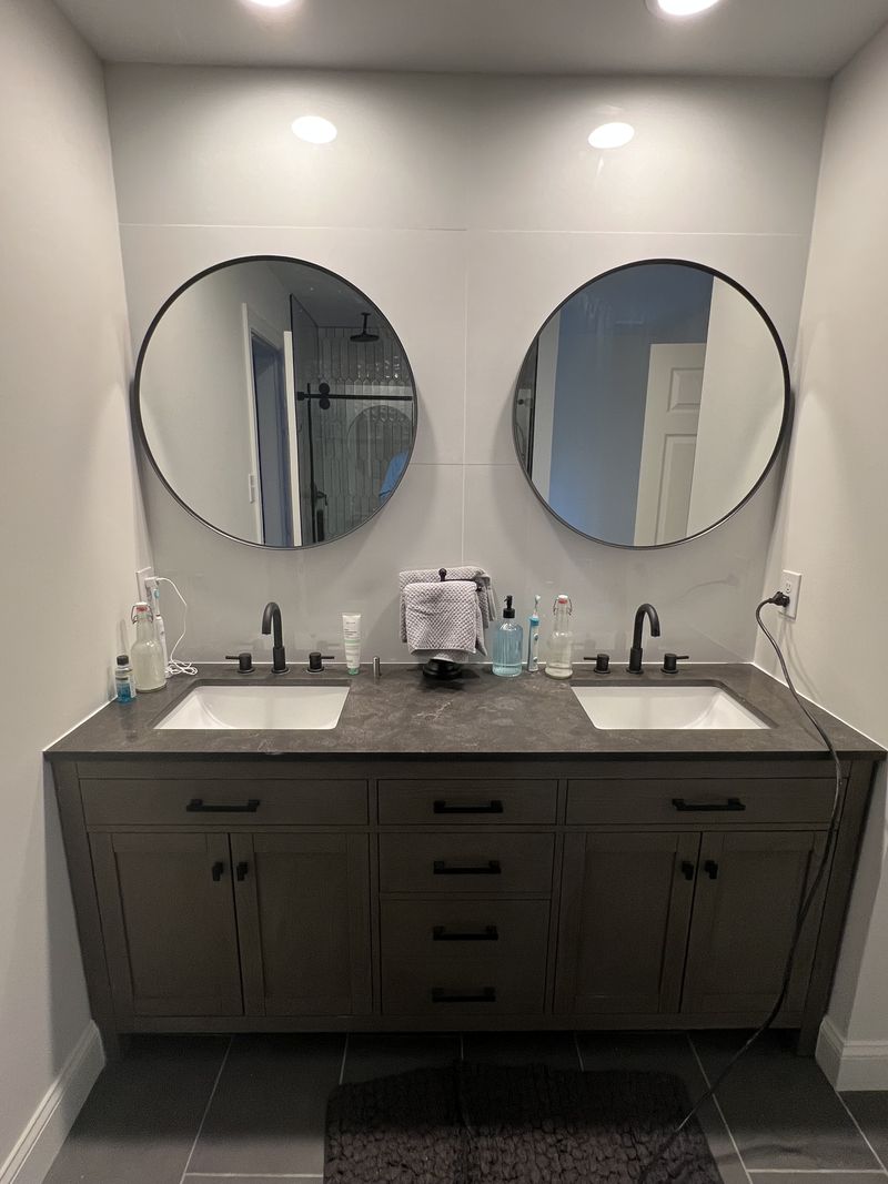 Double vanity with quartz top, round mirrors and matte black fixtures, bathroom remodel in Chester County PA